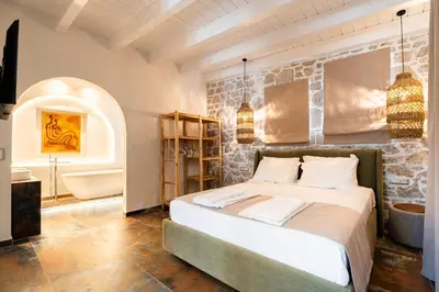 a bedroom with a large bed and a bathroom at Villa Splendide in Rhodes Town