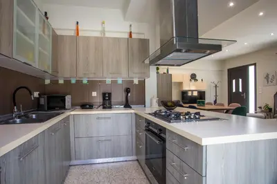 a kitchen with wooden cabinets and a stove top oven at PaMar in Faliraki