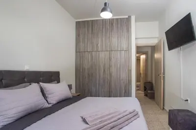 a bedroom with a large bed with a television on the wall at PaMar in Faliraki