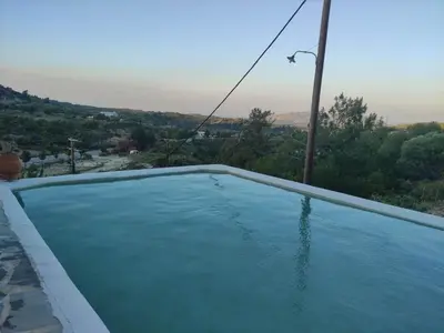 a pool of water with a view of a city at Bianca Suite & Home in Psinthos