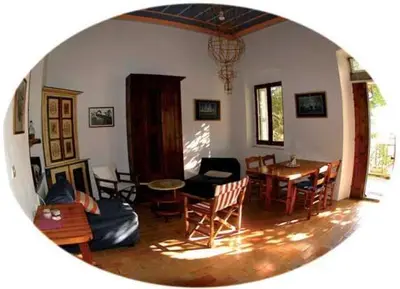 a living room with a table and chairs at MAÏA's House in Symi