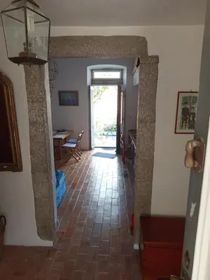 a hallway with a door leading to a dining room at MAÏA's House in Symi