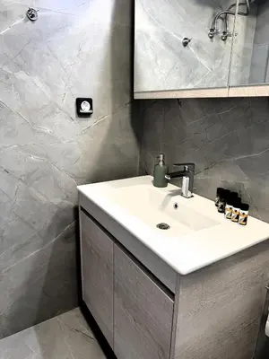 a bathroom with a sink and a mirror at Date Palm Studio in Kremasti