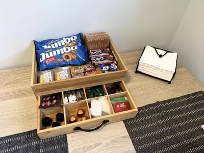 a table with a box of food and some snacks at Date Palm Studio in Kremasti