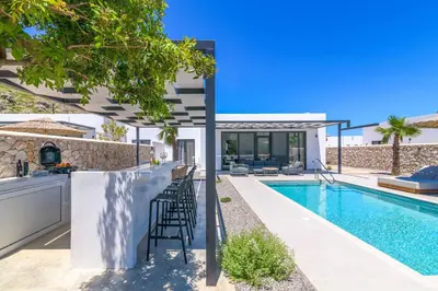 a villa with a swimming pool and a bar at Villa Zen Koan in Kolimbia