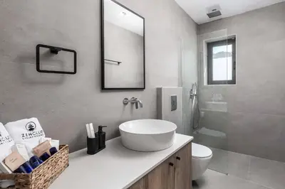 a bathroom with a sink and a toilet and a mirror at Villa Zen Koan in Kolimbia