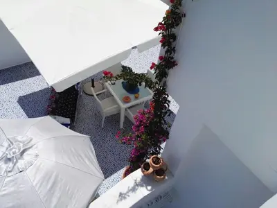 an overhead view of a room with an umbrella and flowers at Bouganville Studios Stegna in Archangelos
