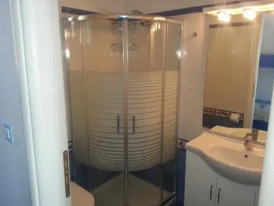 a bathroom with a shower and a sink at Bouganville Studios Stegna in Archangelos