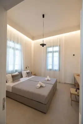 a bedroom with a large bed with towels on it at Casa Alini in Ialyssos