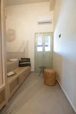 a room with a bench and a table in it at Casa Alini in Ialyssos