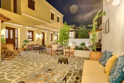 a patio with a table and chairs in a building at Vasileios Moments in Rhodes Town