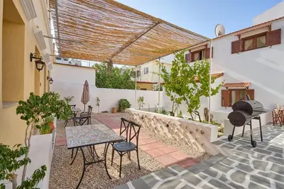 a patio with chairs and a table and a grill at Vasileios Moments in Rhodes Town