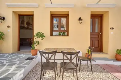 a patio with a table and chairs in front of a house at Vasileios Moments in Rhodes Town