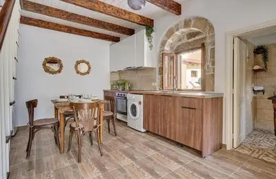 a kitchen with a table and a sink and a stove at Vasileios Moments in Rhodes Town