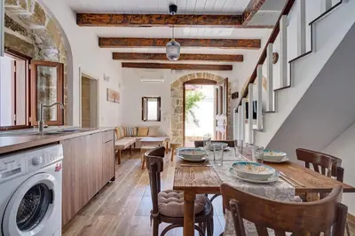 a kitchen with a table and a sink and a dishwasher at Vasileios Moments in Rhodes Town