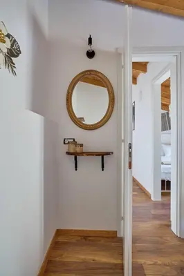 a mirror on the wall of a room with a hallway at Vasileios Moments in Rhodes Town
