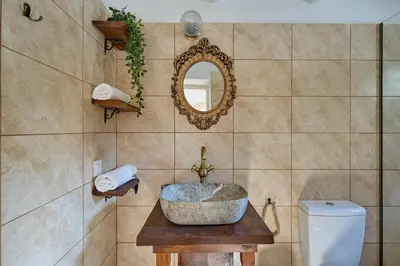 a bathroom with a sink and a toilet and a mirror at Vasileios Moments in Rhodes Town