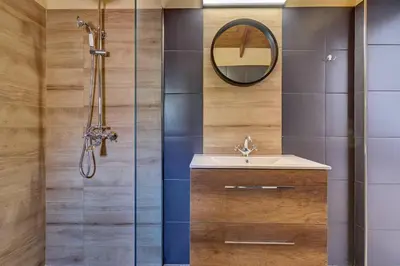 a bathroom with a shower with a sink and a mirror at Vasileios Moments in Rhodes Town