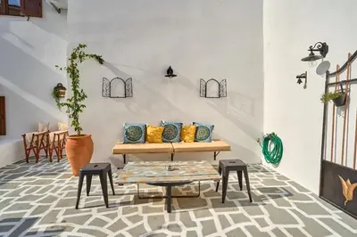 a living room with a table and stools at Vasileios Moments in Rhodes Town