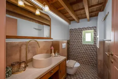 a bathroom with a sink and a toilet at Siliguri Traditional House in Rhodes Town