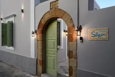 an archway with a green door on a building at Siliguri Traditional House in Rhodes Town