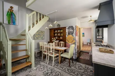 a dining room and kitchen with a table and chairs at Siliguri Traditional House in Rhodes Town