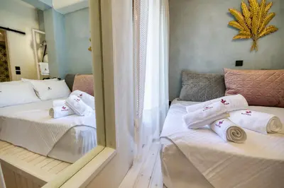 two beds in a room with towels on them at Bastion Luxury Medieval Accommodation in Rhodes Town