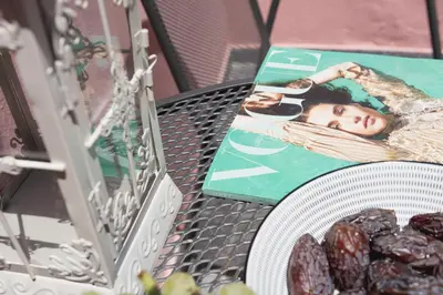 a table with a picture of a girl on a magazine at Bastion Luxury Medieval Accommodation in Rhodes Town