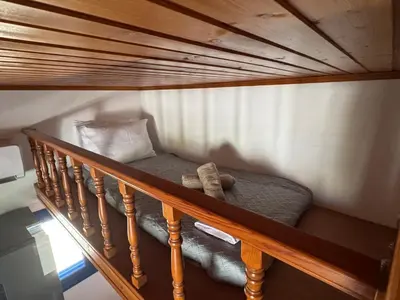 a wooden bunk bed in a stairway with at PARADISE SEA HOUSE a in Haraki