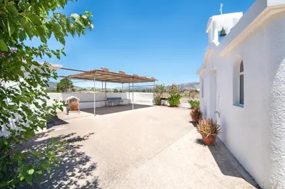 a walkway leading to a white building with a pavilion at PARADISE SEA HOUSE a in Haraki