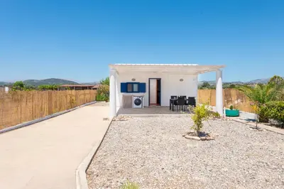 a small white house with a patio at PARADISE SEA HOUSE a in Haraki
