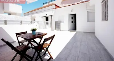 a patio with a table and chairs on a balcony at Platanou 21 Apartments in Kremasti