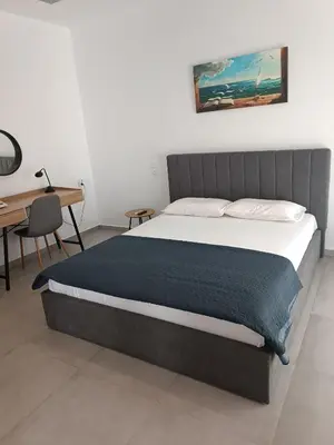 a bed in a room with a desk and a bed sidx sidx sidx at Platanou 21 Apartments in Kremasti