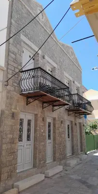 a brick building with a fire escape on top of it at Charistella Apartment in Symi