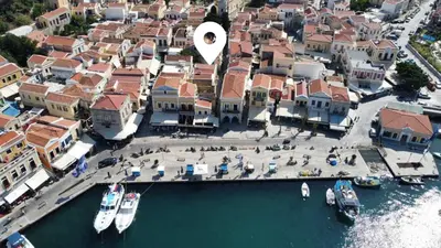 an aerial view of a city with boats in the water at Charistella Apartment in Symi