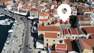 an aerial view of a town with a white circle on top at Charistella Apartment in Symi
