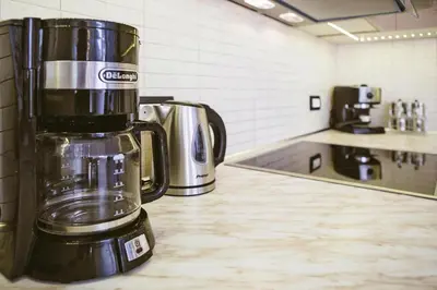 a coffee pot sitting on top of a kitchen counter at Semi-detached house with private pool in Lardos