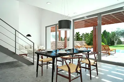 a dining room with a black table and chairs at Semi-detached house with private pool in Lardos