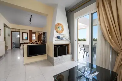 a living room with a tv and a fireplace at Euphoria Villa up to 5 in Ialyssos