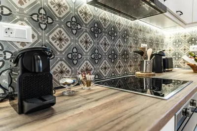 a kitchen with a counter with a black and white wallpaper at Filoxenia House in Archangelos