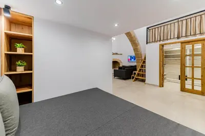 an open living room with a staircase and a living room at Filoxenia House in Archangelos