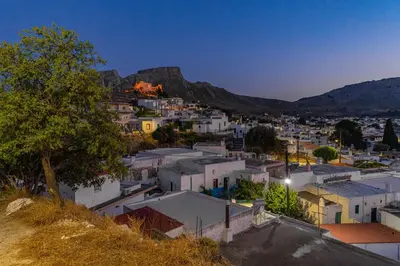 a view of a town with a mountain in the background at Filoxenia House in Archangelos