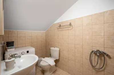 a bathroom with a toilet and a sink at Pissadi House in Symi