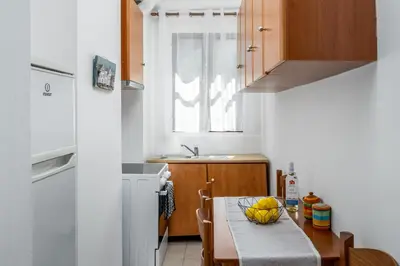 a kitchen with a table with a bowl of bananas on it at Pissadi House in Symi
