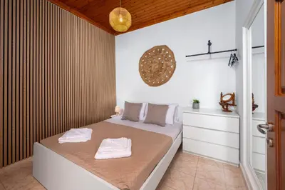 a bedroom with a bed with two towels on it at Pissadi House in Symi