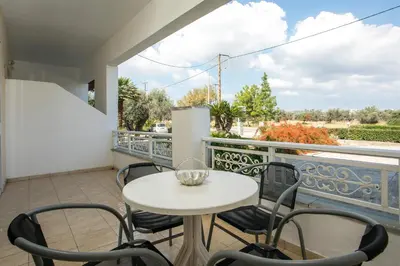 a patio with a table and chairs on a balcony at Dimitris studios & apartments in Faliraki