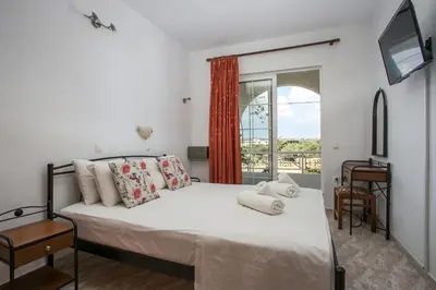 a bedroom with a bed and a window at Dimitris studios & apartments in Faliraki
