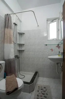 a bathroom with a shower and a toilet and a sink at Dimitris studios & apartments in Faliraki