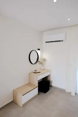 a dressing room with a mirror and a desk at Olympian Apartments in Ialyssos