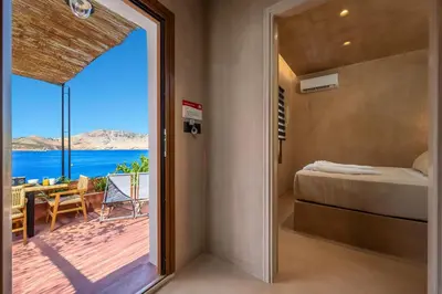 a bedroom with a bed and a view of the ocean at Gama luxury living in Symi